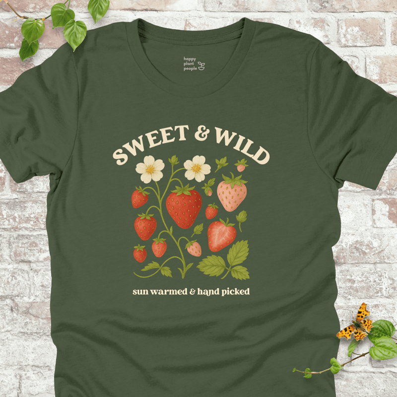 Sweet & Wild Strawberry T-Shirt in Military Green, featuring vintage-style strawberry illustration and cream text on soft Bella+Canvas tee.