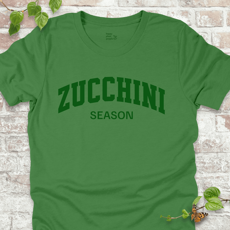 Zucchini Season T-Shirt in Leaf, featuring bold green varsity-style text on soft Bella+Canvas tee.