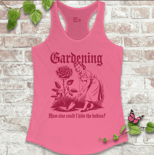 Ladies racerback tank top in pink with “Hide the Bodies” text and garden tools graphic. Funny sleeveless shirt for women who love gardening.