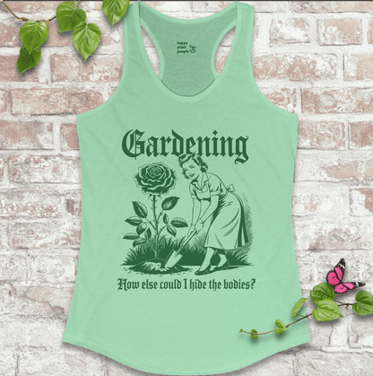 Ladies racerback tank top in mint green with “Hide the Bodies” text and garden tools graphic. Funny sleeveless shirt for women who love gardening.