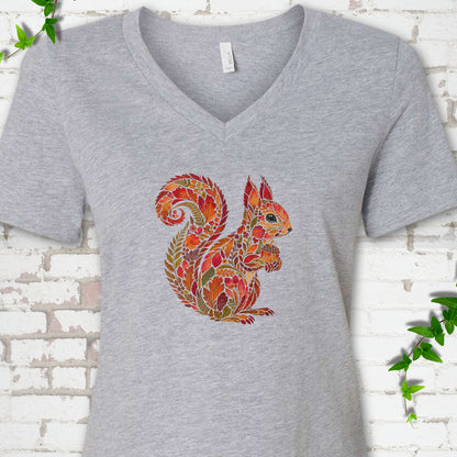 Heather Dust Bella Canvas® V-neck T-shirt flat lay with an autumn squirrel graphic made from colorful leaves, ferns and flowers.
