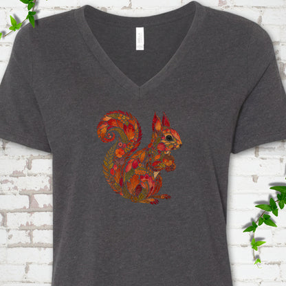 Heather Peach Bella Canvas® V-neck T-shirt flat lay with an autumn squirrel graphic made from colorful leaves, ferns and flowers.