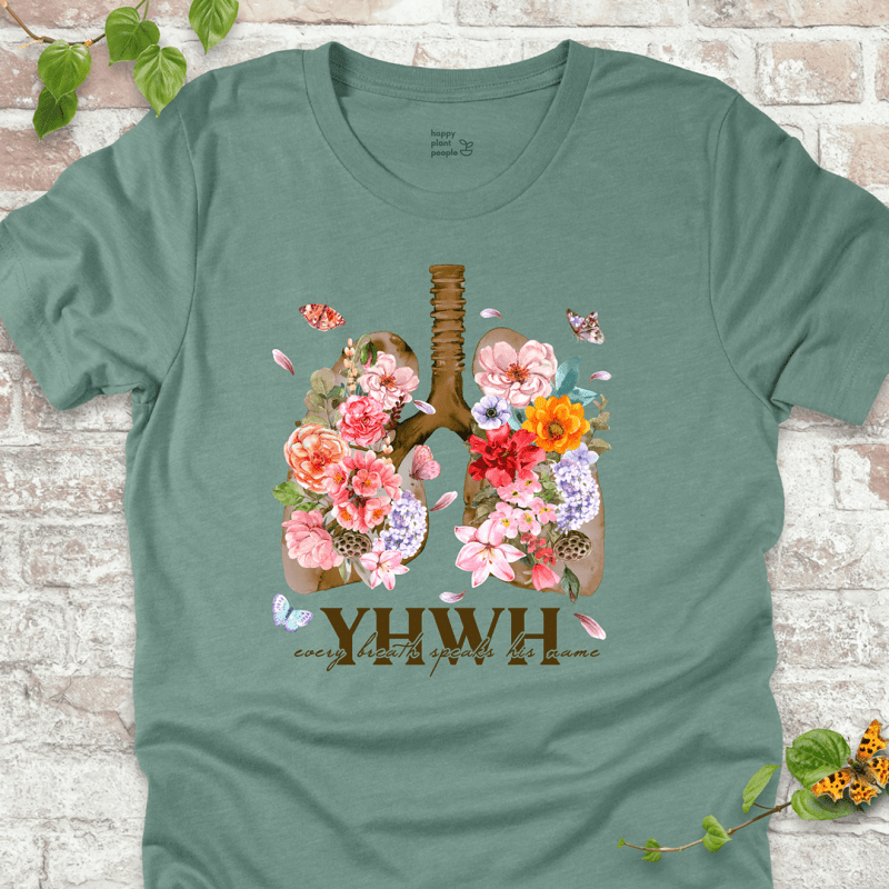 Dusty Blue YHWH Floral T‑Shirt with blooming lungs and fluttering butterflies.
