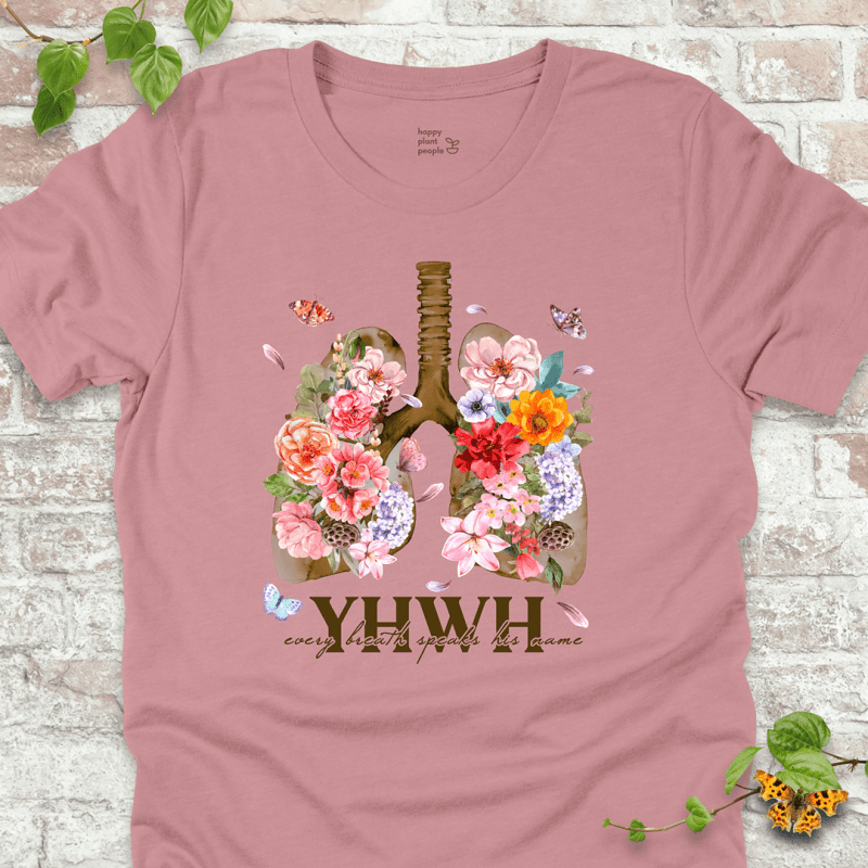 Pink YHWH Floral T‑Shirt with blooming lungs and fluttering butterflies.