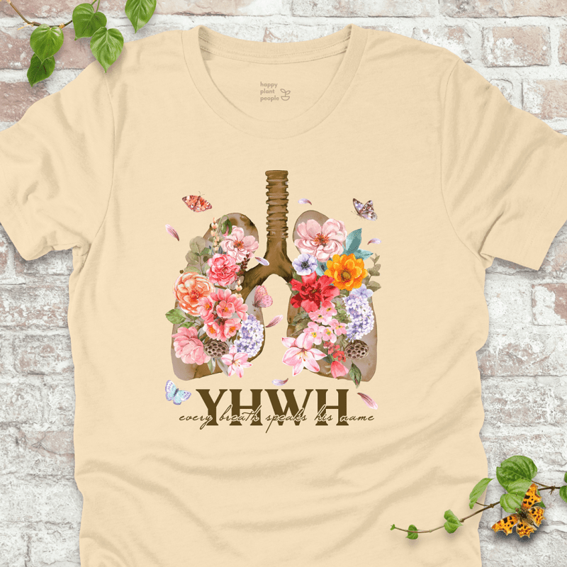 Soft Cream YHWH Floral T‑Shirt with blooming lungs and fluttering butterflies.