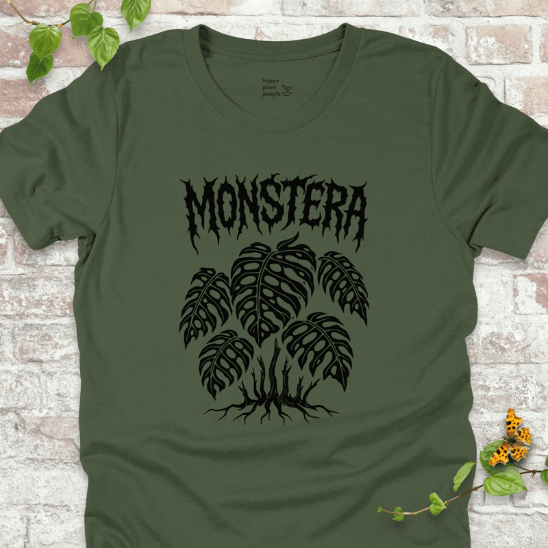 Monstera T-shirt with gothic lettering and Monstera leaves on military green fabric, flat lay with vine accents