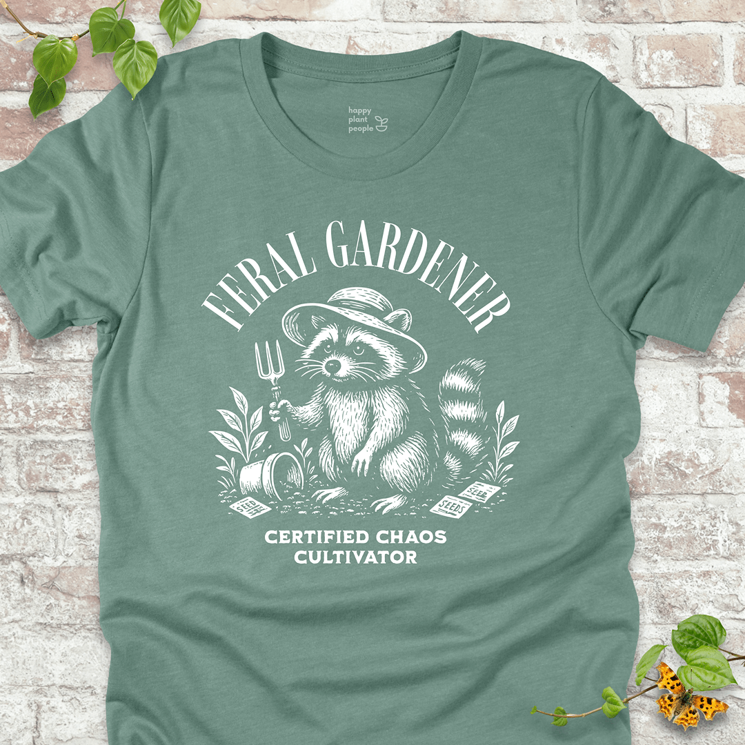 Dusty Blue gardening T-shirt with vintage raccoon and “Certified Chaos Cultivator” slogan. Funny gift for plant lovers and gardeners.