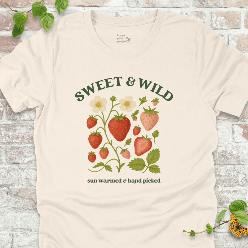 Sweet & Wild Strawberry T-Shirt in Natural, featuring vintage-style strawberry illustration and green text on soft Bella+Canvas tee.