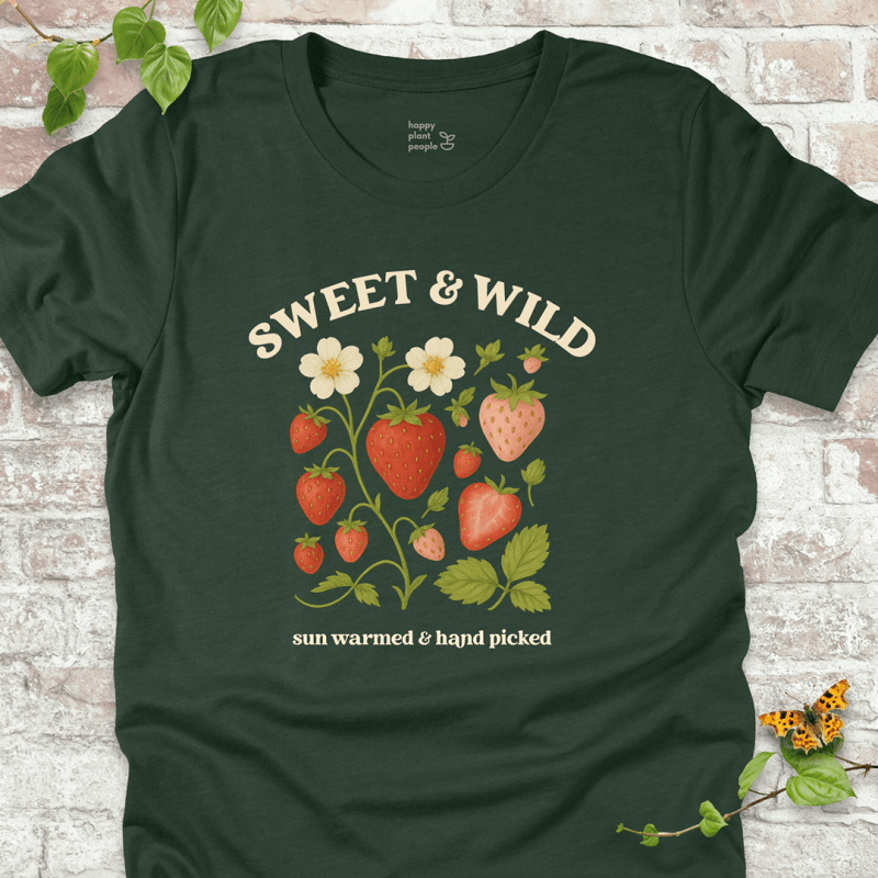 Sweet & Wild Strawberry T-Shirt in Forest Green, featuring vintage-style strawberry illustration and cream text on soft Bella+Canvas tee.
