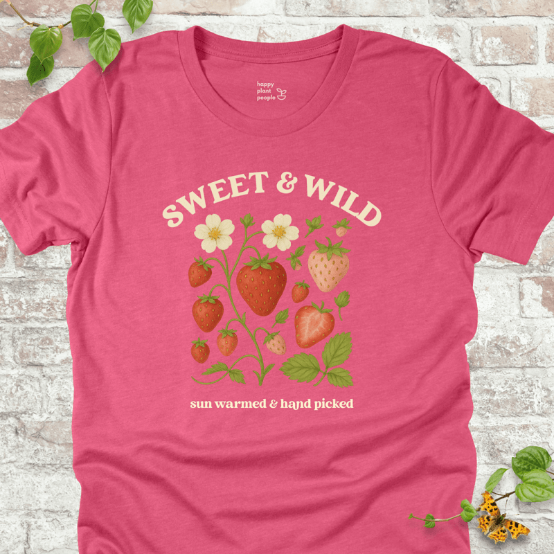 Sweet & Wild Strawberry T-Shirt in Heather Raspberry, featuring vintage-style strawberry illustration and cream text on soft Bella+Canvas tee.