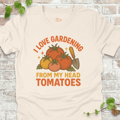 Tomatoes T-Shirt in Natural, featuring a pile of hand-drawn tomatoes, garden trowel, and the pun 'I Love Gardening From My Head Tomatoes' on soft Bella+Canvas tee.