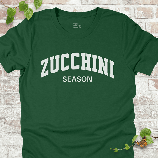 Zucchini Season T-Shirt in Evergreen, featuring bold varsity-style white text on soft Bella+Canvas tee.