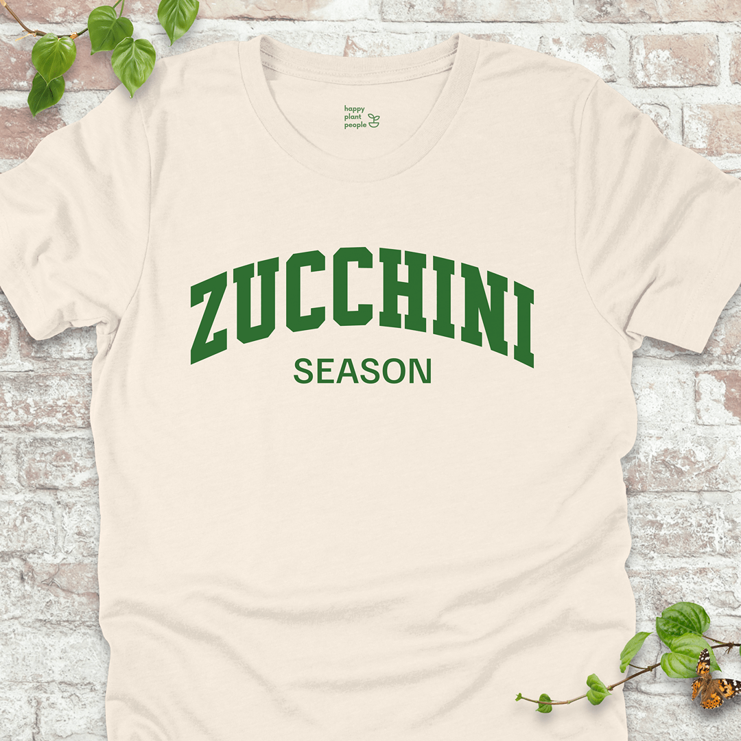 Zucchini Season T-Shirt in Natural, featuring bold green varsity-style text on soft Bella+Canvas tee