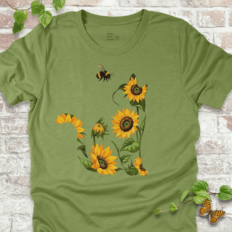 Cute T-shirt in green with a floral cat design made of sunflowers and a bee. Cozy fall garden-themed shirt for plant lovers and cat fans.