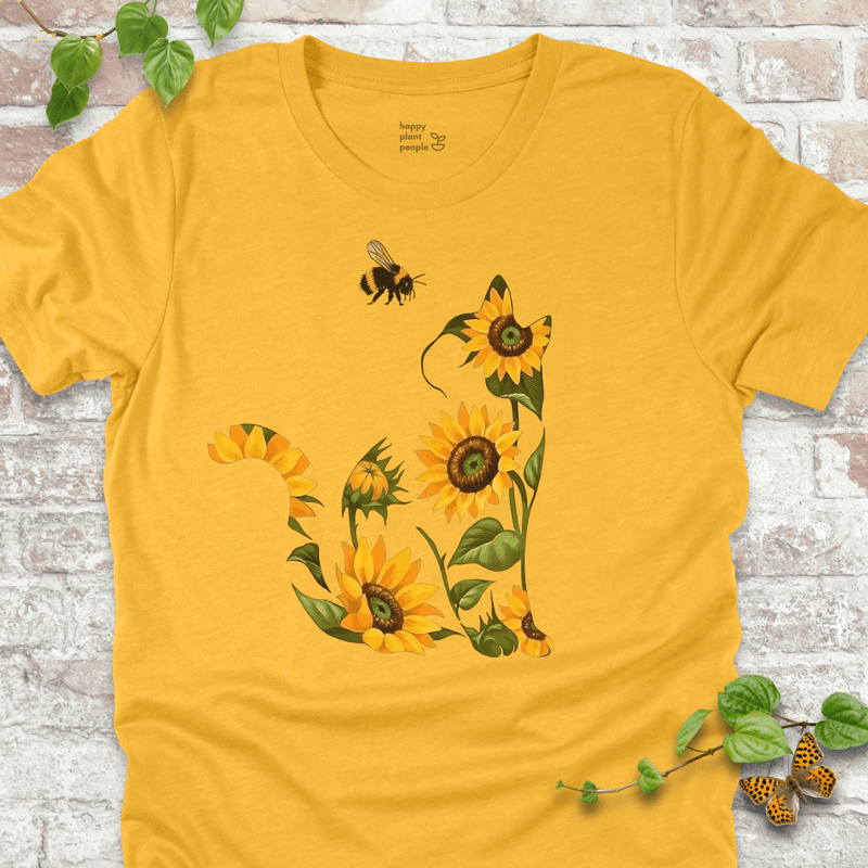 Cute T-shirt in yellow with a floral cat design made of sunflowers and a bee. Cozy fall garden-themed shirt for plant lovers and cat fans.