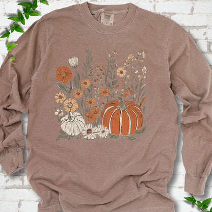 Espresso Comfort Colors® long sleeve T-shirt flat lay featuring an orange pumpkin surrounded by cream and orange wildflowers.