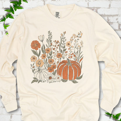Ivory Comfort Colors® long sleeve T-shirt flat lay featuring an orange pumpkin surrounded by cream and orange wildflowers.
