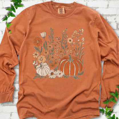 Yam Comfort Colors® long sleeve T-shirt flat lay featuring an orange pumpkin surrounded by cream and orange wildflowers.