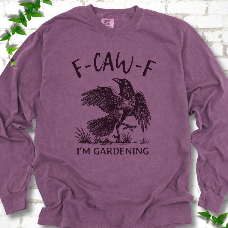 Berry Comfort Colors® long sleeve T-shirt flat lay featuring a black crow with F-CAW-F I'm Gardening text.
