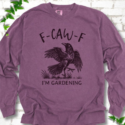 Berry Comfort Colors® long sleeve T-shirt flat lay featuring a black crow with F-CAW-F I'm Gardening text.