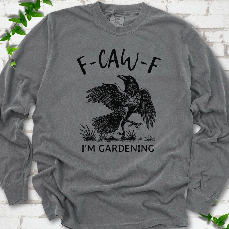Pepper Comfort Colors® long sleeve T-shirt flat lay featuring a black crow with F-CAW-F I'm Gardening text.