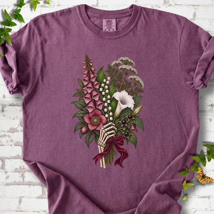 Berry Comfort Colors® T-shirt flat lay featuring a poisonous flower bouquet held by skeletal hands.