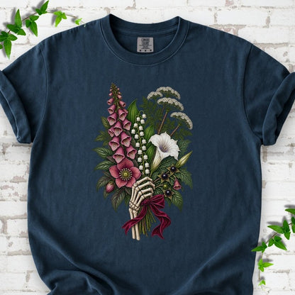 Midnight Comfort Colors® T-shirt flat lay featuring a poisonous flower bouquet held by skeletal hands.