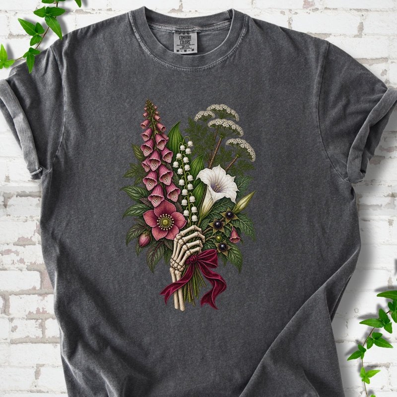 Pepper Comfort Colors® T-shirt flat lay featuring a poisonous flower bouquet held by skeletal hands.