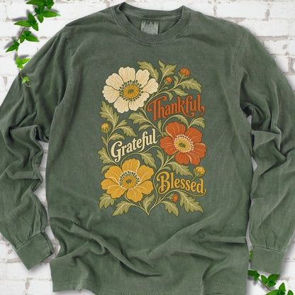 Hemp long sleeve T-shirt flat-lay mockup with orange, cream and yellow flowers framing "Thankful, Grateful, Blessed" lettering.
