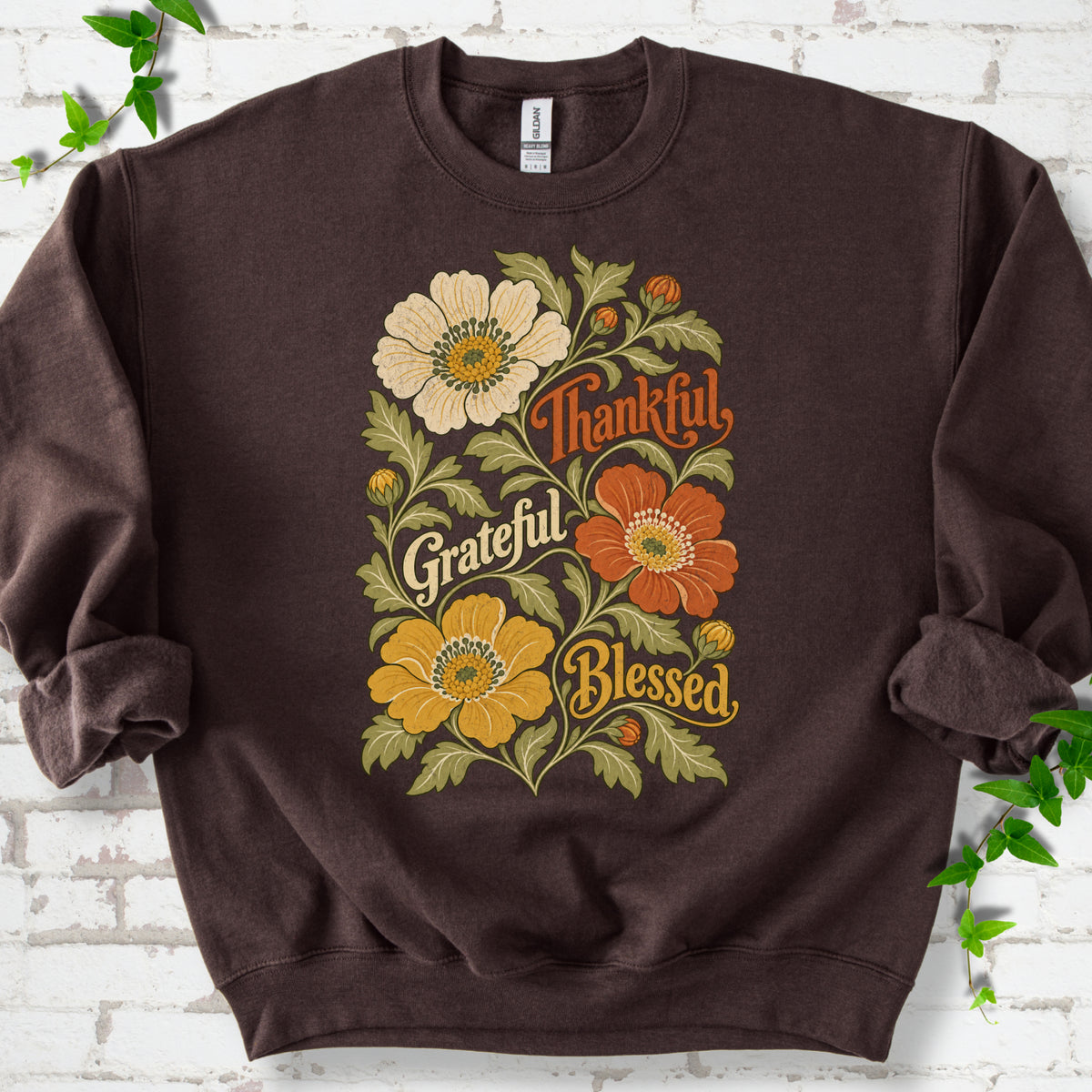 Dark Chocolate sweatshirt flat-lay mockup with orange, cream and yellow flowers framing "Thankful, Grateful, Blessed" lettering.