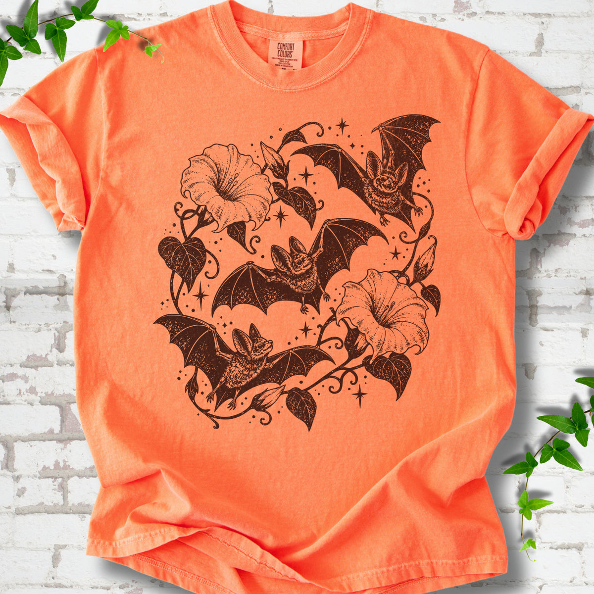 Bats In Bloom botanical bat T-shirt in Melon with black bats and trumpet flowers