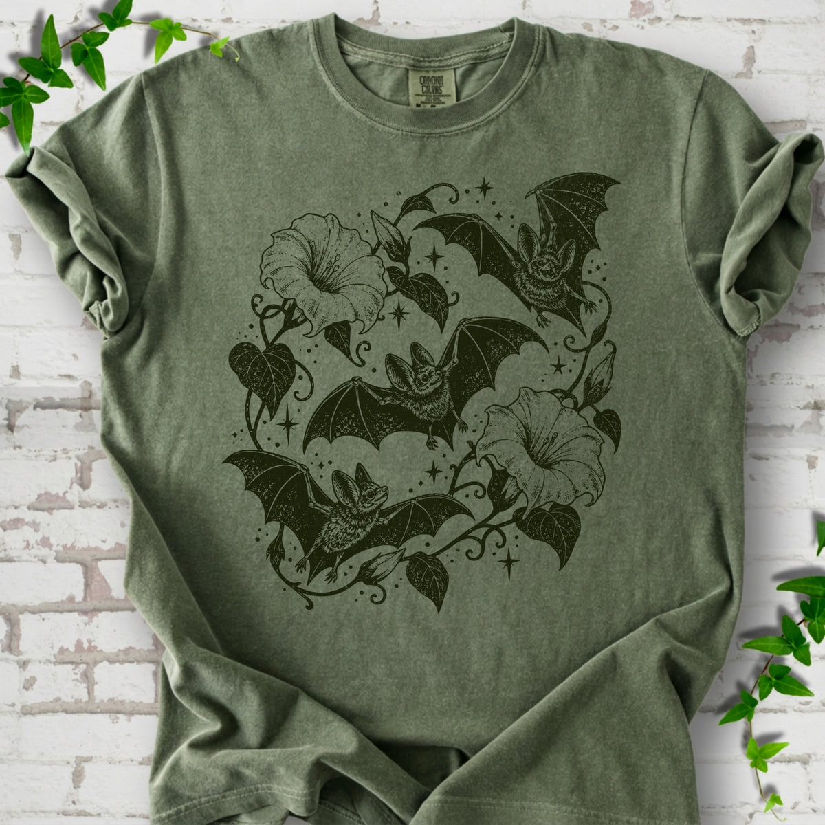 Bats In Bloom botanical bat T-shirt in Moss with black bats and trumpet flowers