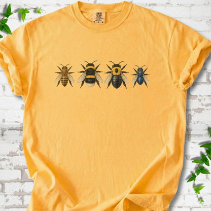 Citrus yellow short sleeve t-shirt with a row of four bees across the chest: a slim golden honey bee, a fuzzy black and yellow bumble bee, a glossy black bee with a yellow collar and a small metallic blue bee, flat lay on white brick with ivy