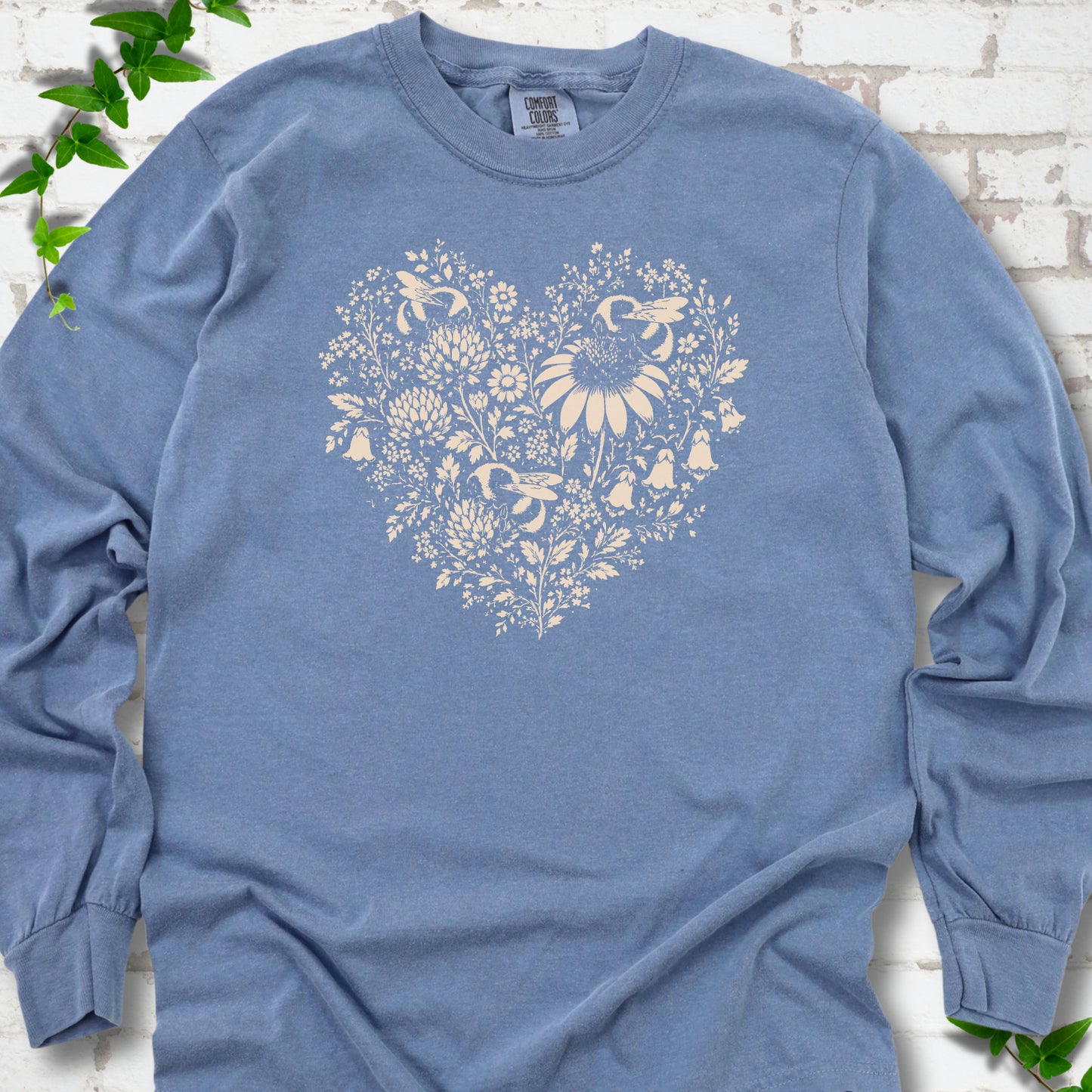 Blue Jean Comfort Colors® long sleeve T-shirt front mockup featuring three bumblebees among wildflowers in a heart-shaped design.