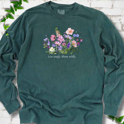 Blue Spruce Comfort Colors® long sleeve T-shirt front mockup featuring colorful wildflowers and the words “Live simply. Bloom wildly.”