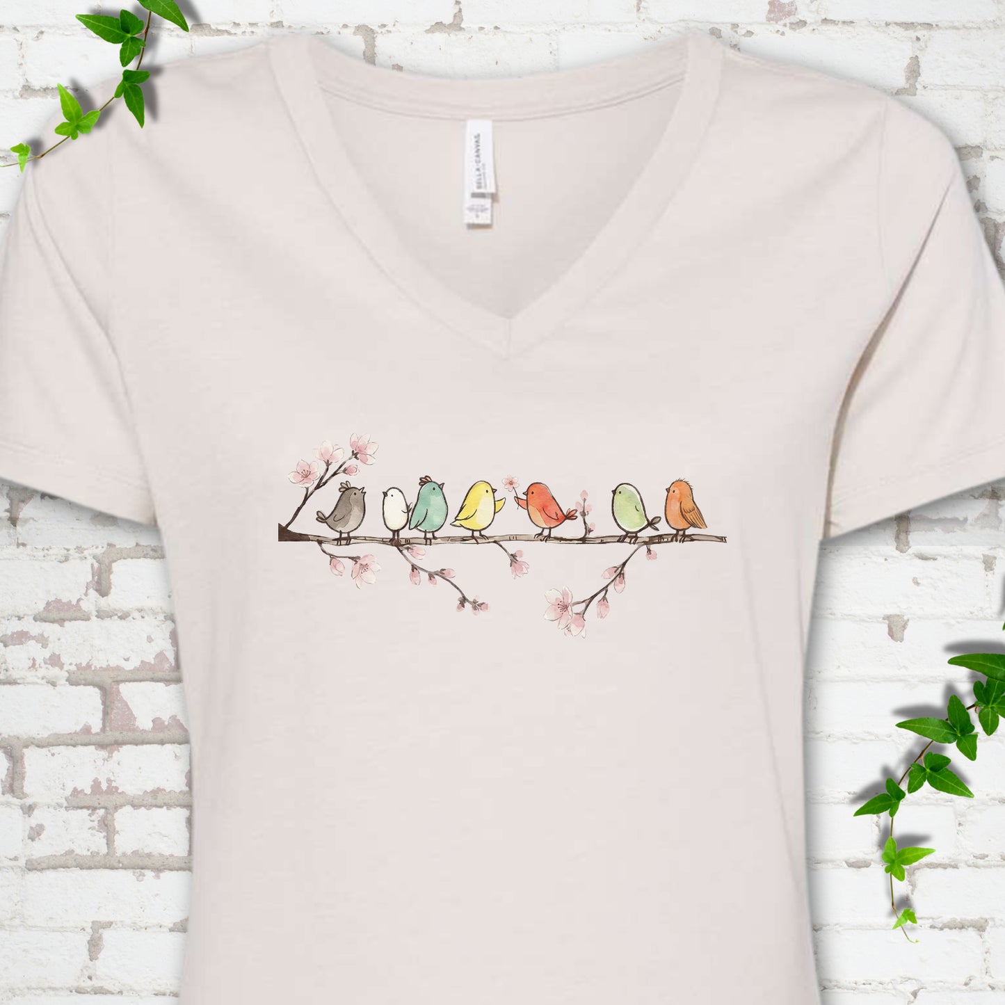 Heather Dust Bella Canvas® V-neck T-shirt front mockup featuring watercolor-style birds on a flowering blossom branch.