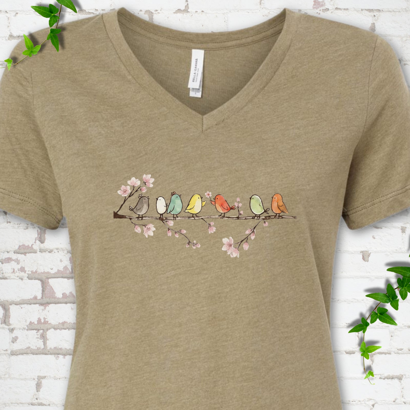 Heather Olive Bella Canvas® V-neck T-shirt front mockup featuring watercolor-style birds on a flowering blossom branch.