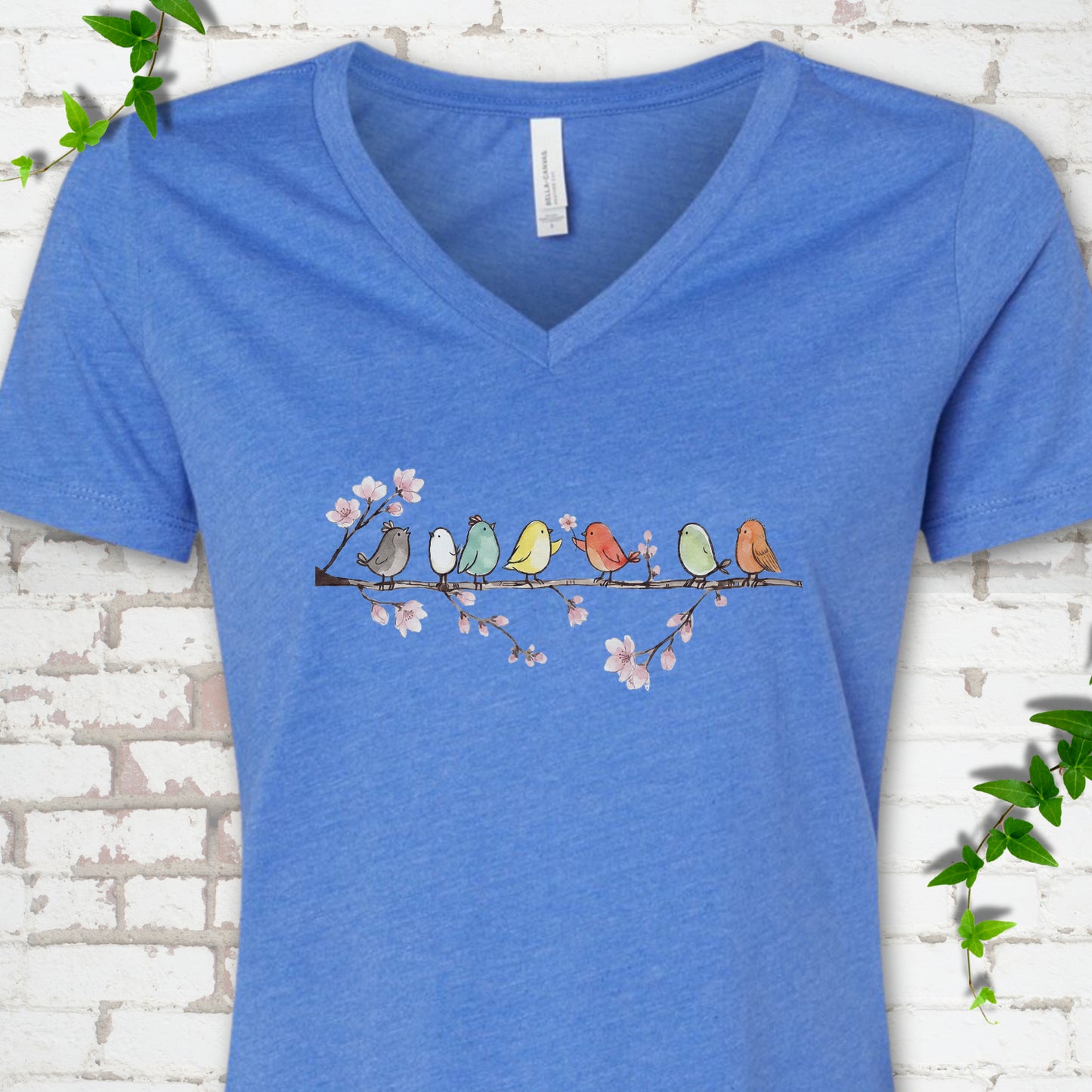 Heather True Royal Bella Canvas® V-neck T-shirt front mockup featuring watercolor-style birds on a flowering blossom branch.