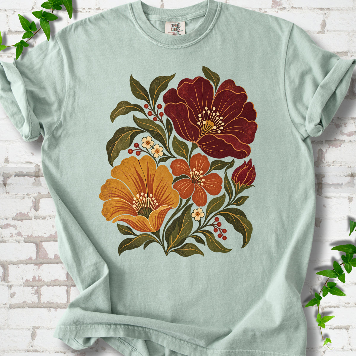 Bay T-shirt front-view mockup with a large burgundy, ochre and rust retro floral graphic.