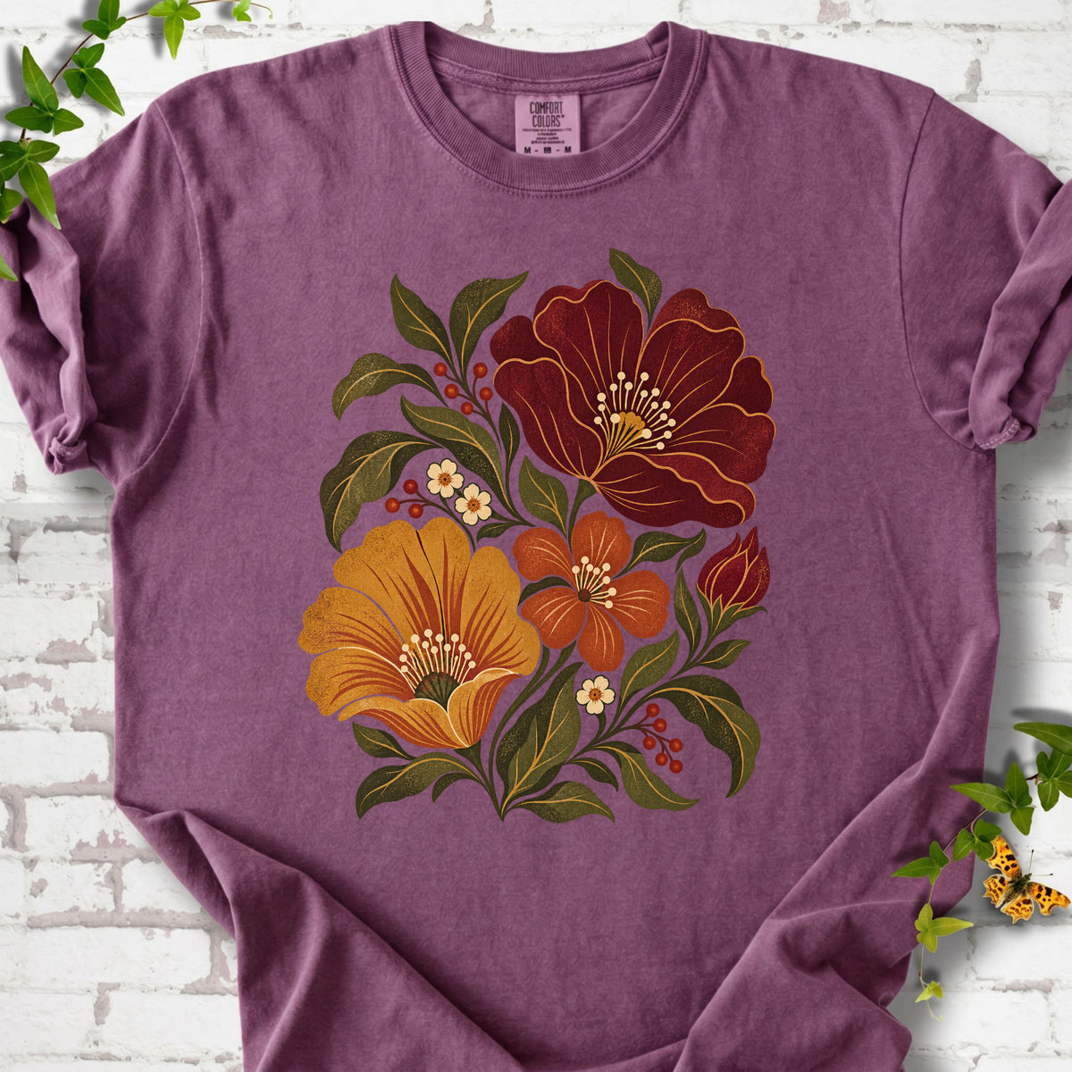 Berry T-shirt front-view mockup with a large burgundy, ochre and rust retro floral graphic.
