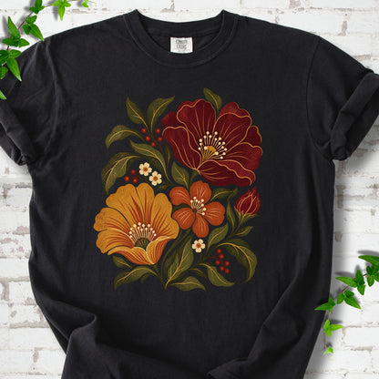Black T-shirt front-view mockup with a large burgundy, ochre and rust retro floral graphic.