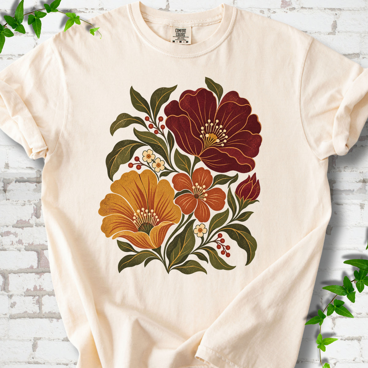 Ivory T-shirt front-view mockup with a large burgundy, ochre and rust retro floral graphic.