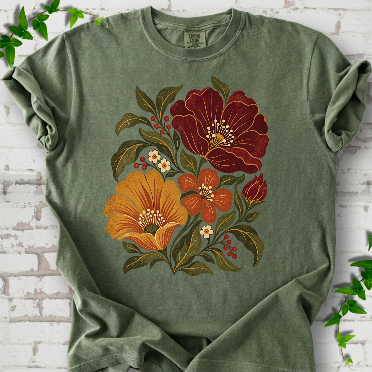 Moss T-shirt front-view mockup with a large burgundy, ochre and rust retro floral graphic.