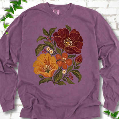 Berry long sleeve T-shirt front-view mockup with a large burgundy, ochre and rust retro floral graphic.