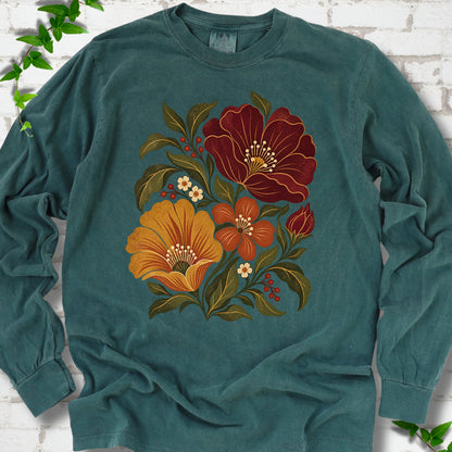 Blue Spruce long sleeve T-shirt front-view mockup with a large burgundy, ochre and rust retro floral graphic.