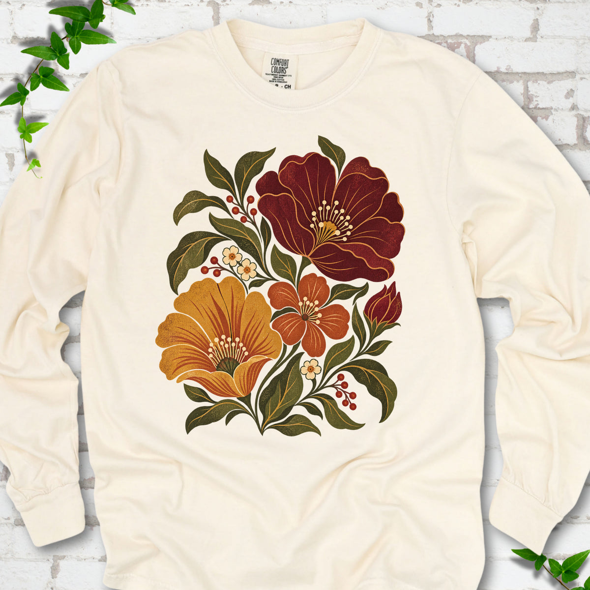 Ivory long sleeve T-shirt front-view mockup with a large burgundy, ochre and rust retro floral graphic.