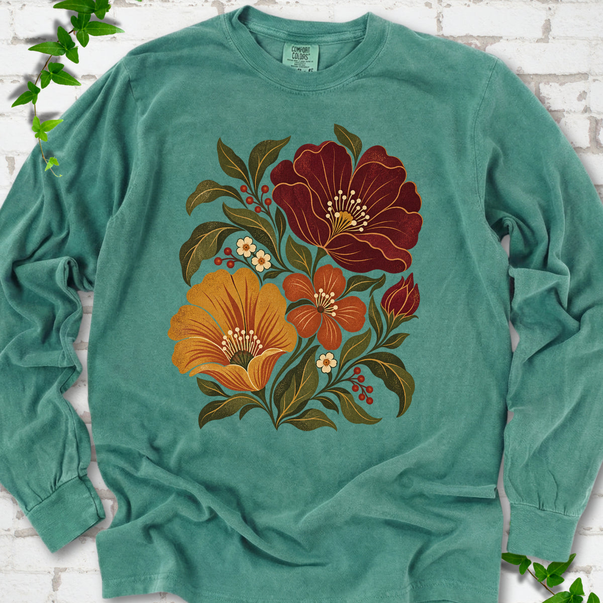 Light Green long sleeve T-shirt front-view mockup with a large burgundy, ochre and rust retro floral graphic.