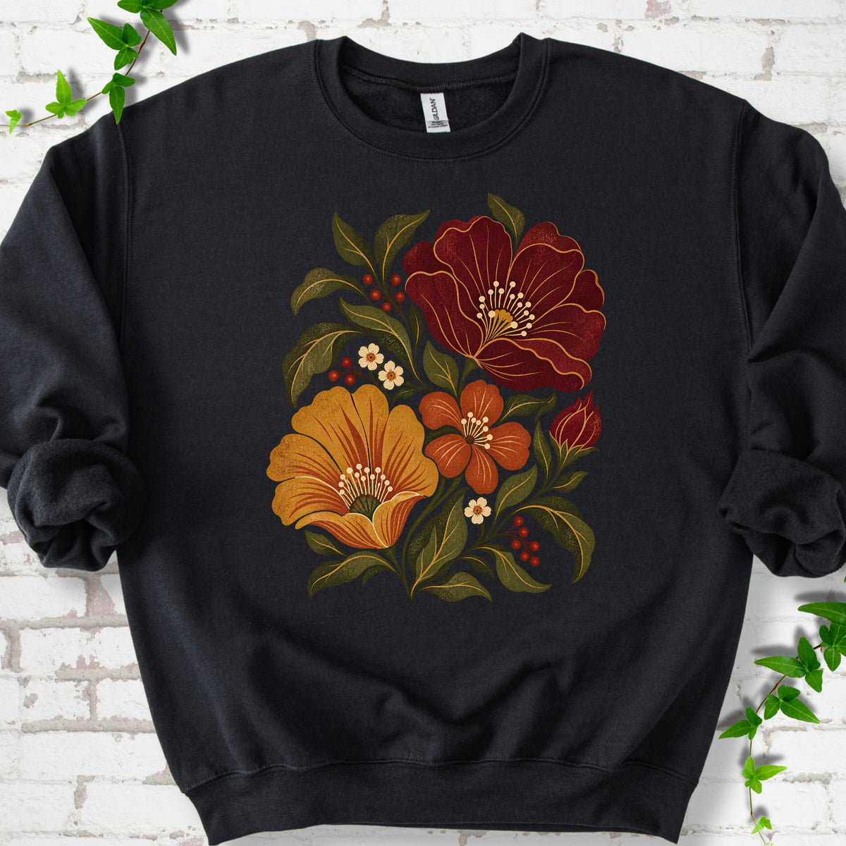 Black sweatshirt front-view mockup with a large burgundy, ochre and rust retro floral graphic.