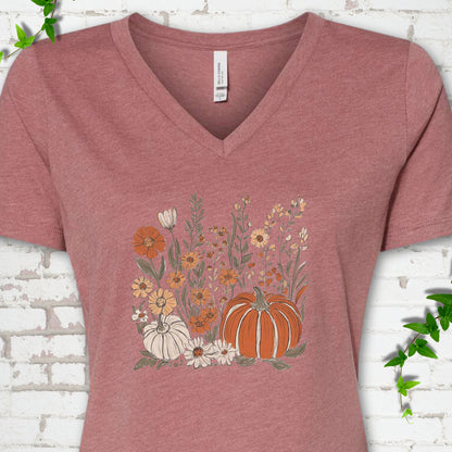 Heather Mauve Bella Canvas® V-neck T-shirt flat lay featuring an orange pumpkin surrounded by cream and orange wildflowers.