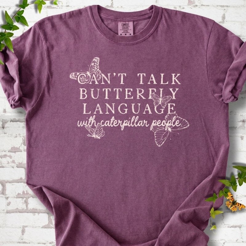 Berry Comfort Colors® T-shirt featuring a cream Can't Talk Butterfly Language with Caterpillar People graphic with butterflies